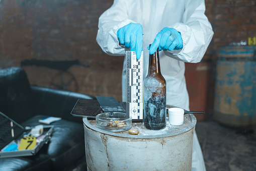 Forensic scientist measuring physical evidences on a crime scene