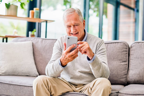 istock Shot of a senior man using a phone at a clinic 1367834961