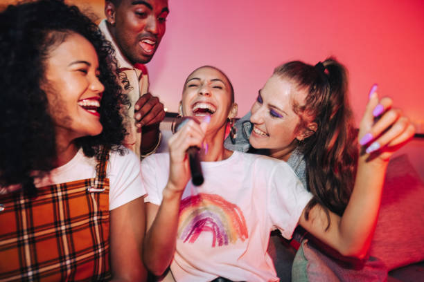 istock Joyful friends singing during karaoke night 1367835134