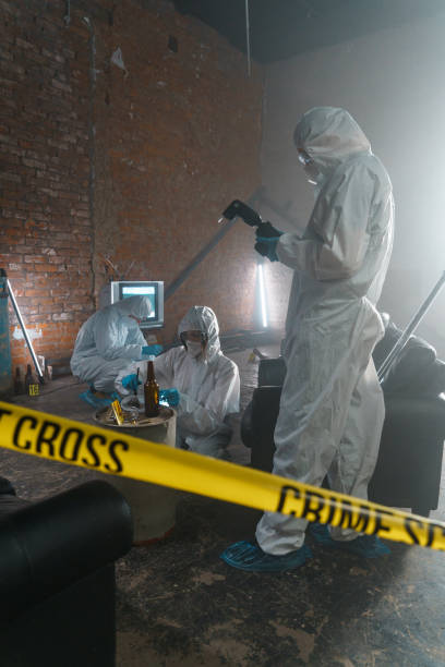 istock Forensic scientists at the crime scene behind the barricade tape 1367835390