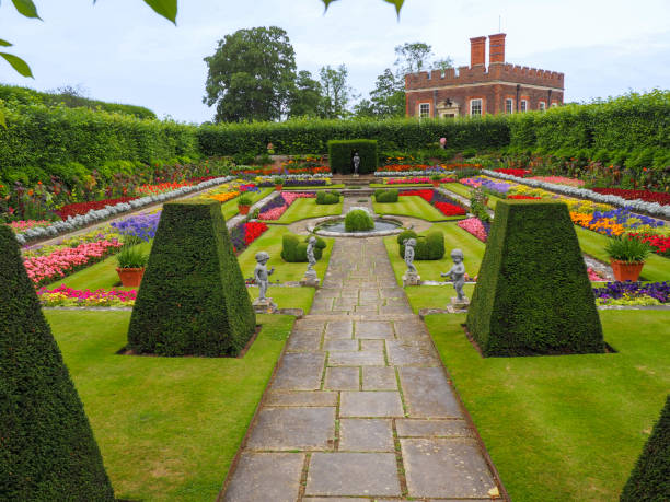 Hampton Court gardens in summer Hampton Court, London, United Kingdom, 04.08.2016: Hampton Court gardens in summer hampton court stock pictures, royalty-free photos & images