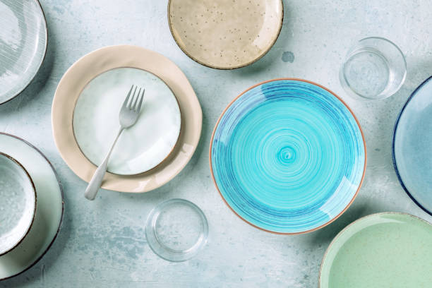 istock Modern tableware set with cutlery and a vibrant blue plate, overhead shot 1367838092