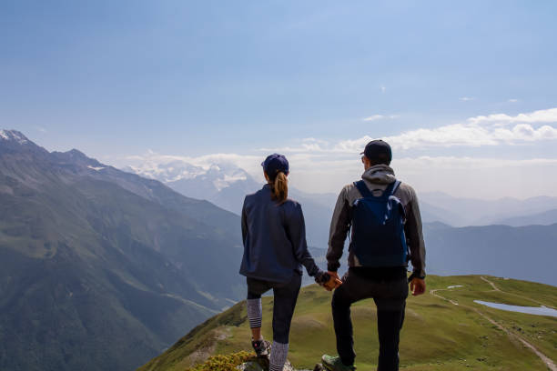 istock Koruldi Lake Trek - Two hikers with panoramic view on Svaneti mountain range, Caucasus. 1367839768