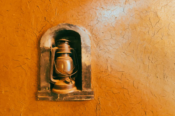 Old kerosene lamp hangs on the wall as a background for decoration