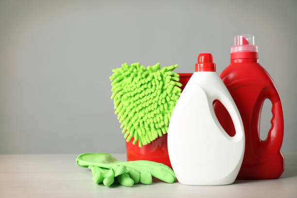 istock Bucket and cleaning products on grey table. Space for text 1367841180