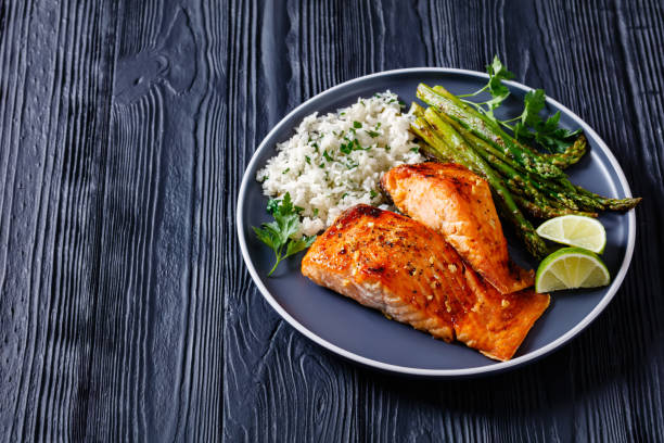 istock fried salmon fish fillet with rice and asparagus 1367841377