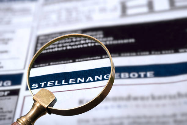istock Newspaper with job advertisements and a magnifying glass 1367841856