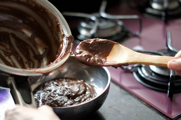 Making chocolate brigadeiro, a typical Brazilian sweet. Defocused background. stock photo