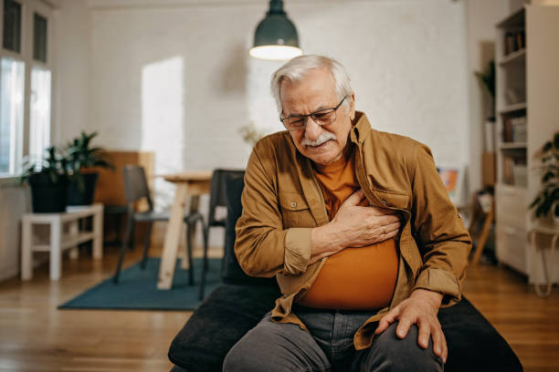 Senior man has chest pain stock photo