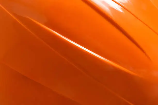 Photo of Orange plastic material as background, top view