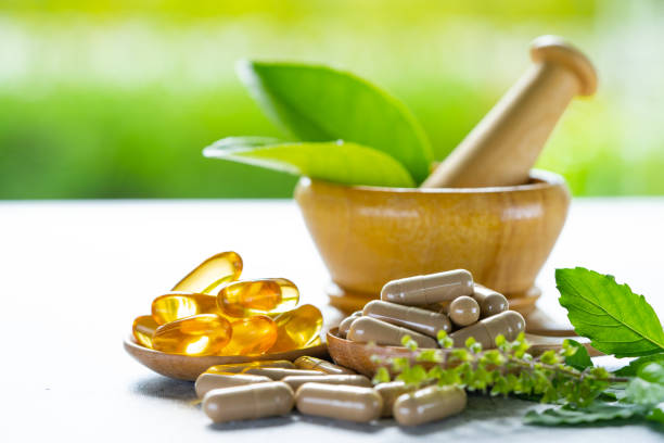 Alternative medicine herbal organic capsule with vitamin E omega 3 fish oil, mineral, drug with herbs leaf natural supplements for healthy good life. stock photo