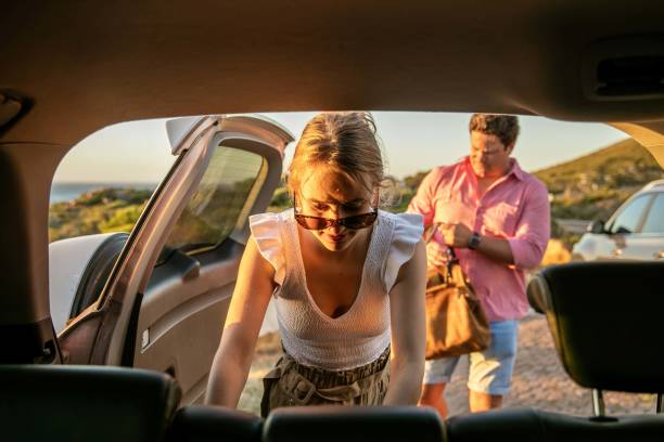 istock Young couple packing bags into car. 1367842966