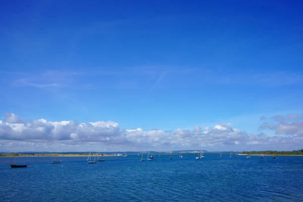 Small boats floating in blue ocean