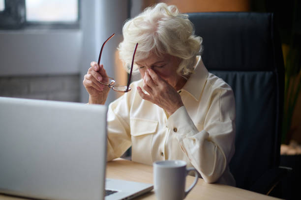 istock Woman taking off glasses touching her closed eyes 1367845524