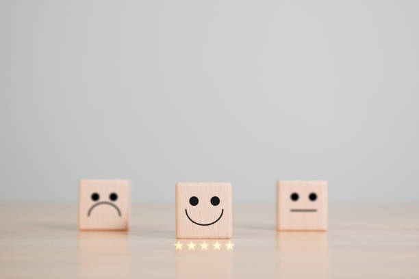 istock Smile face symbol on wooden cube blocks. satisfaction and feedback concept. 1367845802