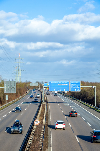 view to german highway A5 with speed reduction to 120 km and blue signage for next exit near Frankfurt