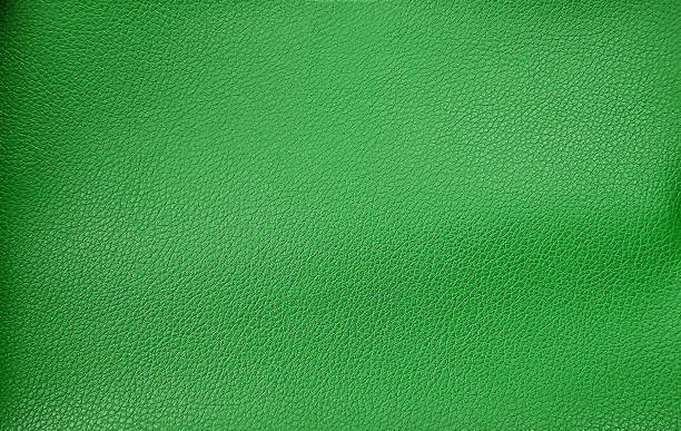 green leather texture for background. bright green leather upholstery for loft interior style. pattern of leather texture in macro view. retro style background.