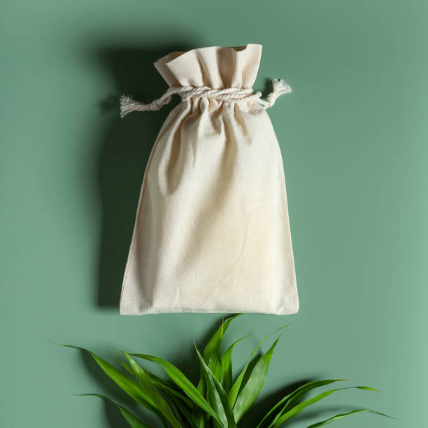istock Cotton reusable bag bamboo on green background. Eco shopping. 1367848320