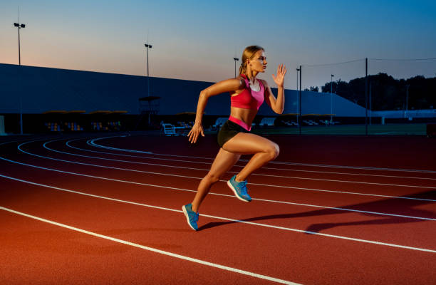 istock Runner sprinting towards success on run path running athletic track. Goal achievement concept 1367848419