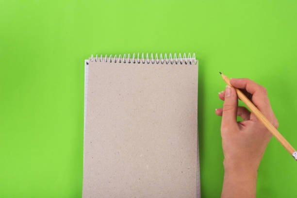 istock writting in the notebook with pencil on green background bussiness concept 1367849574