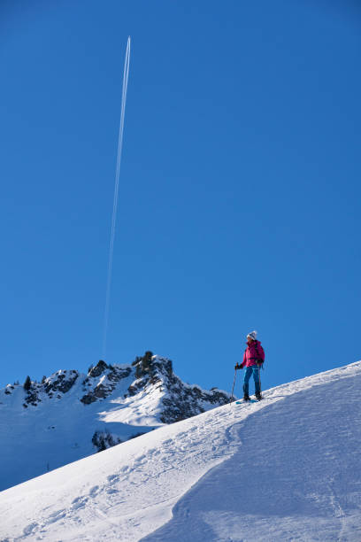 woman snowshoeing in the Kleinwalsertal, Vorarlberg Austria nice senior woman snowshoeing in the Kleinwalsertal in Riezlern, Vorarlberg, Austria kleinwalsertal stock pictures, royalty-free photos & images