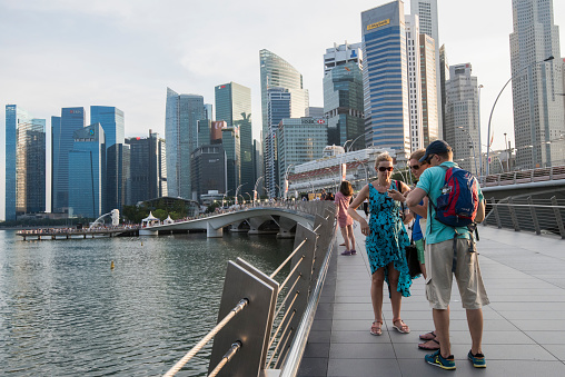 Singapore, Singapore - September 08, 2019 : Tourists and locals walk along the Marina Bay Promenade.