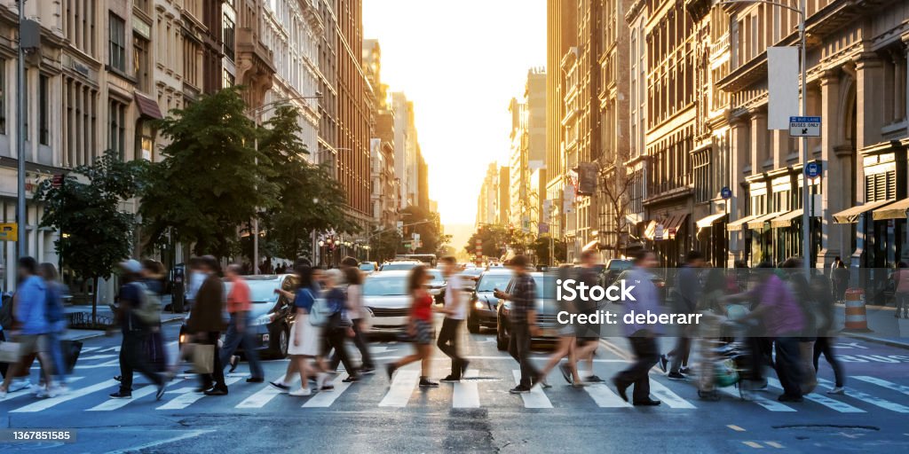 Crowds of people walking across a busy crosswalk at the intersection of 23rd Street and 5th Avenue in Manhattan New York City Crowds of people walking across a busy crosswalk at the intersection of 23rd Street and 5th Avenue in Manhattan New York City NYC People Stock Photo