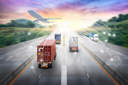 Truck transport with red container on highway road at sunset, Depth Blur effect, logistics import export background and cargo transport industry concept