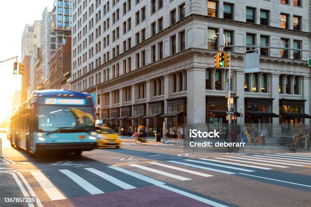 Busy Street Scene With People Bus And Taxi At The Intersection Of 23rd And 5th Avenue In New York City With Sunlight Background Stock Photo - Download Image Now