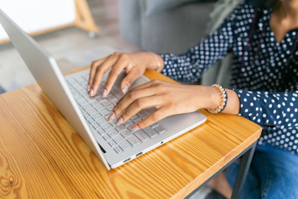 istock Beautiful young black woman study or works from laptop online remote work university classes 1367857693