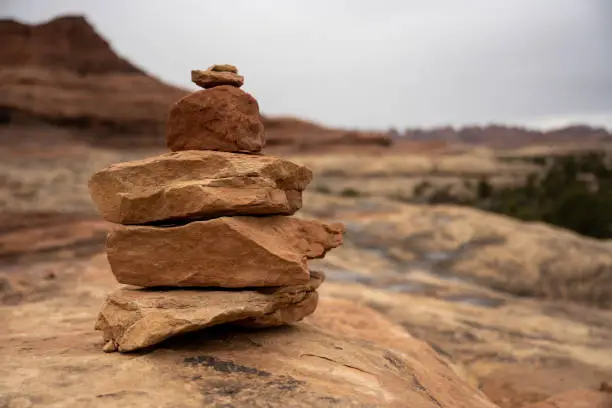 Cairn Of Six Rocks Stands To Mark The Way of trail over smooth rock