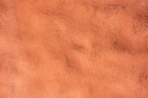 istock Coral Painted Texture of Adobe Wall 1367859287