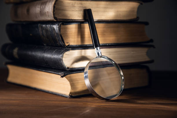 istock A magnifying glass on a stack of books 1367859454