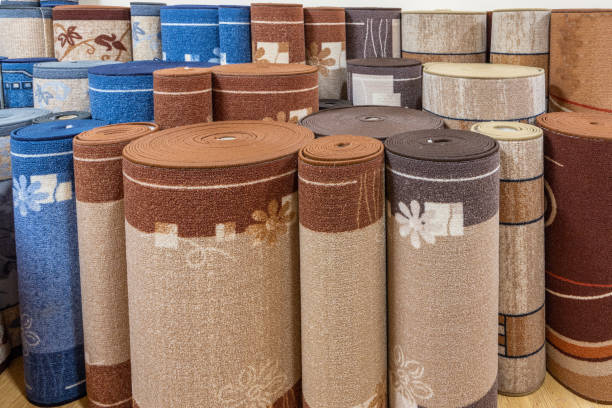 istock Many colorful carpets in the store. Variety selection rolled up carpets 1367860834