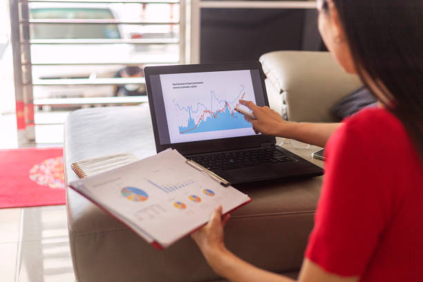 istock Female entrepreneur analyzing graph on laptop at workplace 1367862054