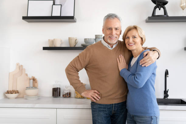 istock Adorable senior couple posing and looking at camera 1367863228