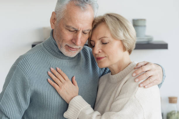 istock Tender senior couple hugging in their apartment 1367863301