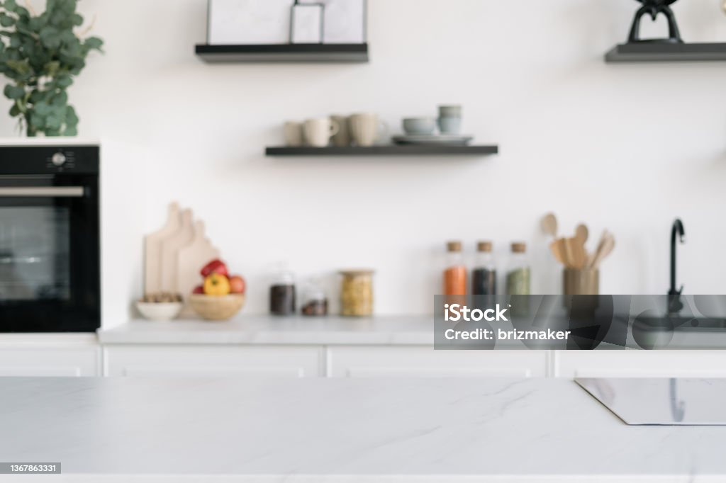Nordic kitchen interior design with large surface Closeup of stylish Nordic kitchen interior design with large surface and induction cooker. Modern kitchenware and decor. Luxury apartment for sale Backgrounds Stock Photo