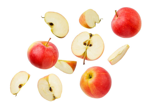istock Falling apples whole and pieces on a white background, cut. Isolated 1367865839