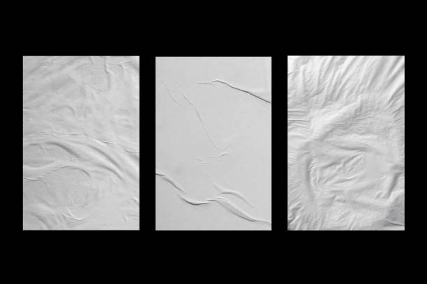 istock Three sheets of white paper with folds on a black background. 1367866287
