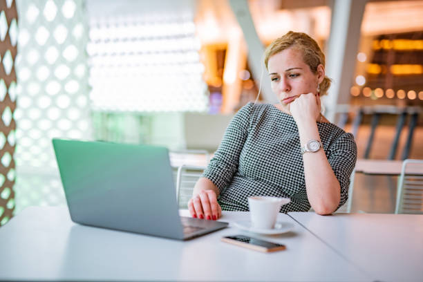 istock Woman looking at laptop in the office 1367866616
