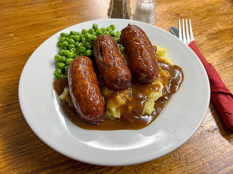 Sausage and mash dinner with peas and gravy