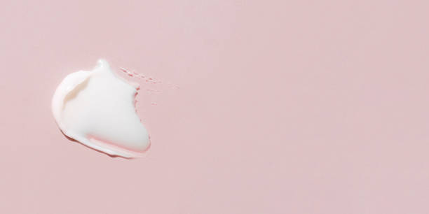 istock Smear of cream on a pink background. 1367867474