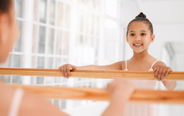 istock Shot of a little girl practicing ballet in a dance studio 1367867633