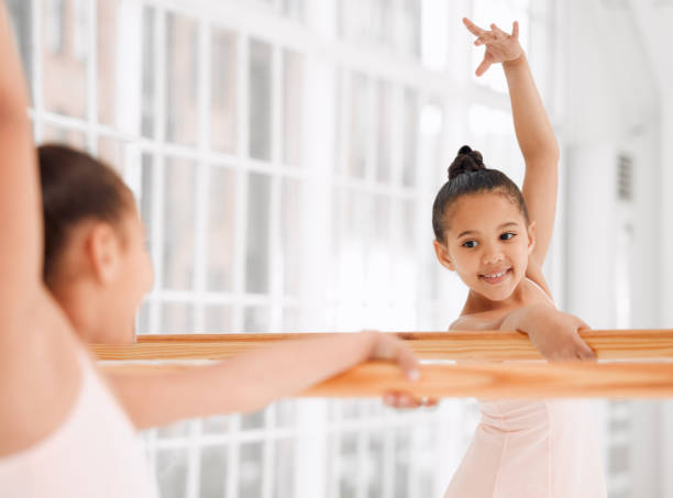 istock Shot of a little girl practicing ballet in a dance studio 1367867634