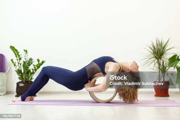 Two athletes performing duo acroyoga poses Stock Photo by Photology75