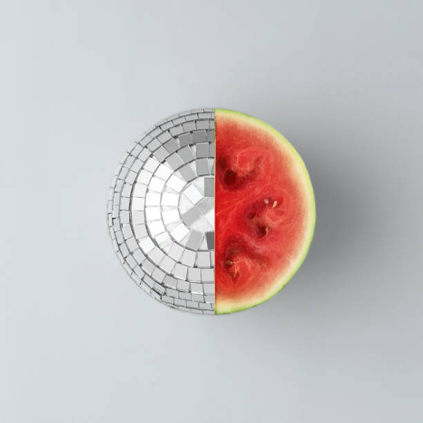 istock Mirror ball in the form of a watermelon on a gray background. Creative fruit concept. 1367868676