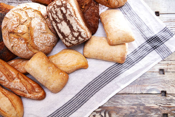 istock Top view of different types of bread on wooden table 1367868679