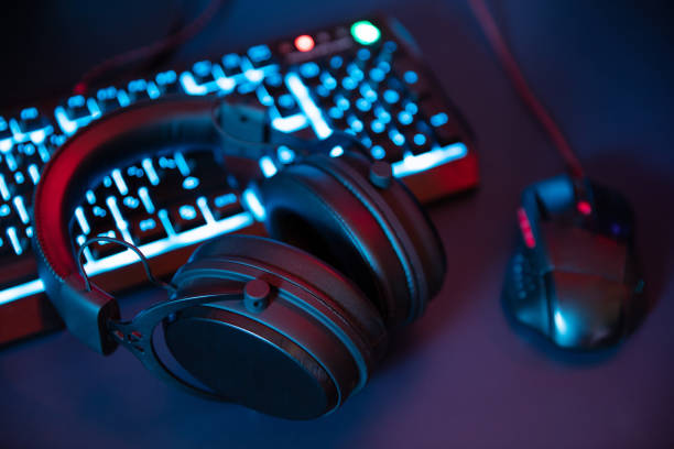 Modern gaming equipment lying on the desk in night stock photo