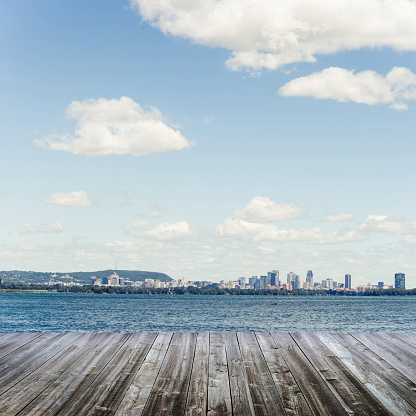 Montreal seen from a wooden deck from the south shore of the St. Lawrence River.